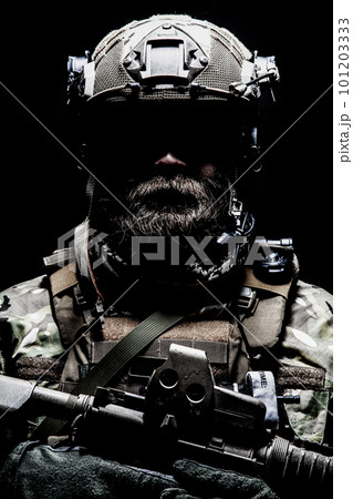 Close up, low key half length portrait of bearded commando fighter, army special forces soldier, private military company mercenary. Masculinity, determination and strength 101203333