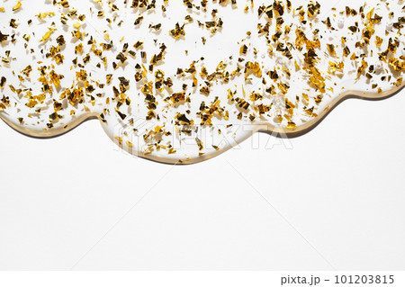 Liquid gel abstract cosmetic background. Smear of transparent moisturizing product with golden particles 101203815