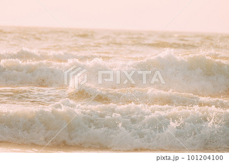 Evening sunlight sunshine above sea. Amazing landscape scenery. Sea ocean water surface with foaming small waves. Sea ocean water surface with Crashing waves. Copy space. Nature background Evening sunlight sunshine above sea. Amazing landscape scenery. Sea ocean water surface with foaming small waves. Sea ocean water surface with Crashing waves. Copy space. Nature background 101204100