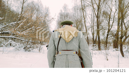 Men Dressed As White Guard Soldiers Of Imperial Russian Army In Russian Civil War s Marching Through Snowy Winter Forest. Historical Reenactment Men Dressed As White Guard Soldiers Of Imperial Russian Army In Russian Civil War s Marching Through Snowy Winter Forest. Historical Reenactment 101204121
