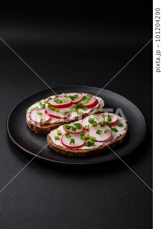 Delicious sandwich or bruschetta with cream cheese radish and green onions Delicious sandwich or bruschetta with cream cheese radish and green onions 101204290