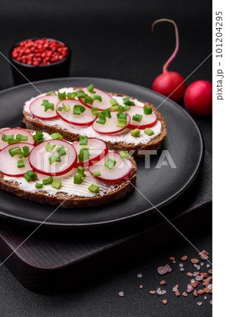 Delicious sandwich or bruschetta with cream cheese radish and green onions Delicious sandwich or bruschetta with cream cheese radish and green onions 101204295