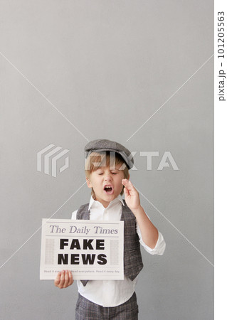 Newsboy shouting against grunge wall background. Boy selling fake news 101205563