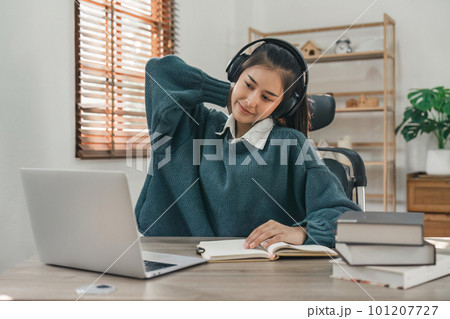 Asian young student in casual video call and doing stretch oneself from study online class. Online distance e-learning education concept 101207727