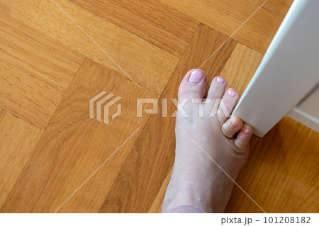 Woman hit furniture with the little toe. Incident at home. Injury of foot little finger Woman hit furniture with the little toe. Incident at home. Injury of foot little finger 101208182