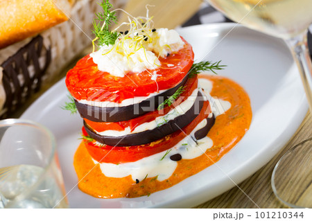 Stack of fried eggplant with tomatoes and piquant sauce Stack of fried eggplant with tomatoes and piquant sauce 101210344
