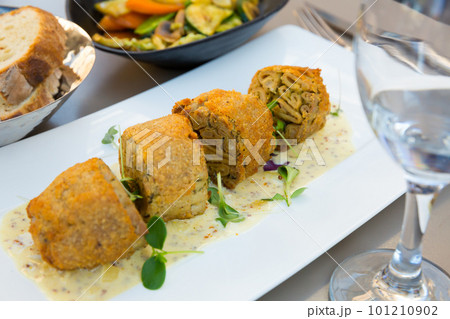 Pan-fried pieces of Andouillette 101210902