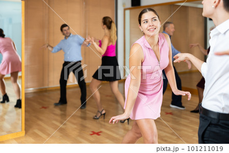 Young happy couple performing a paired dance in ballroom 101211019