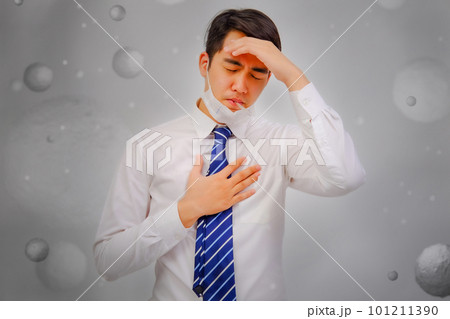 Asian man wear masks to protect PM 2.5 dust and air pollution and headache and sickness, air pollution concept, healthcare concept. 101211390