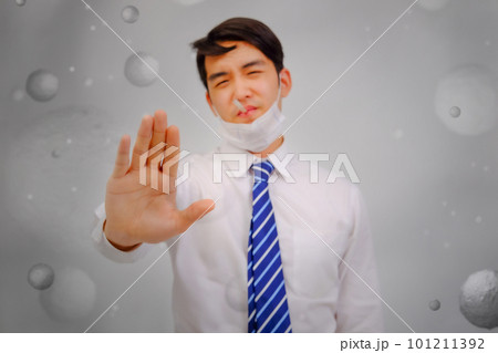 Asian man wear masks raise your hand to protect PM 2.5 dust and air pollution and headache and sickness, air pollution concept, healthcare concept. Asian man wear masks raise your hand to protect PM 2.5 dust and air pollution and headache and sickness, air pollution concept, healthcare concept. 101211392