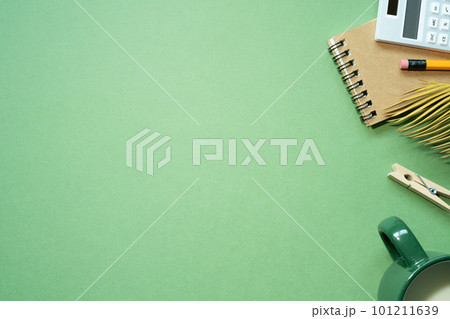 School office supplies. notebook, calculator, pencil, cup of milk on green desk background. flat lay, top view, copy space School office supplies. notebook, calculator, pencil, cup of milk on green desk background. flat lay, top view, copy space 101211639