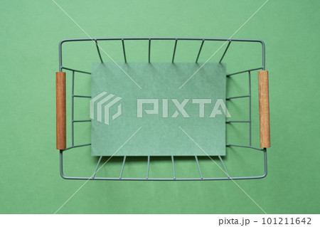 Empty basket with copy space on green background. top view 101211642