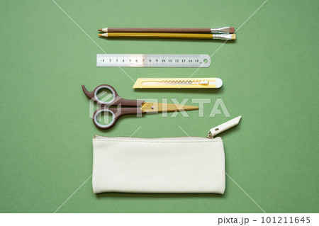 School office writing supplies and pencil case on green desk. top view, copy space 101211645