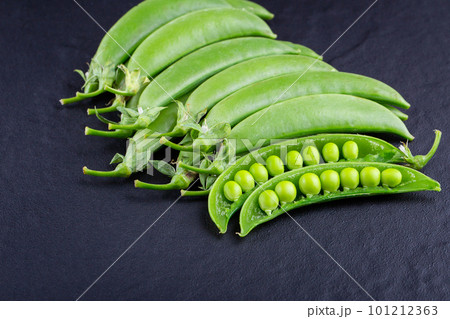 Sugar snap peas with mint on a rustic wood background Sugar snap peas with mint on a rustic wood background 101212363