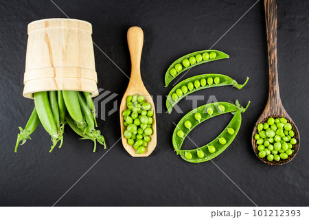 Sugar snap peas with mint on a rustic wood background Sugar snap peas with mint on a rustic wood background 101212393