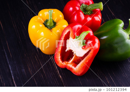 Three sweet peppers on a wooden background, Cooking vegetable salad Three sweet peppers on a wooden background, Cooking vegetable salad 101212394