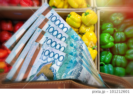 Rising prices for vegetables and agricultural products in Kazakhstan. Tenge in a wallet against the background of a counter with bell peppers 101212601