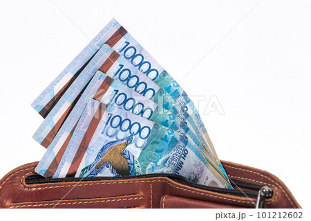 Tenge banknotes in a purse on a white background Tenge banknotes in a purse on a white background 101212602