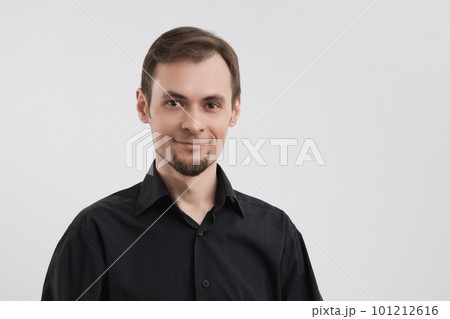Caucasian calm smiling man 30s in a black shirt portrait on white background 101212616