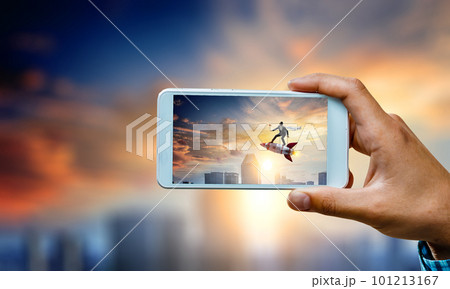 Hand holding smartphone mobile . Mixed media Hand holding smartphone mobile . Mixed media 101213167