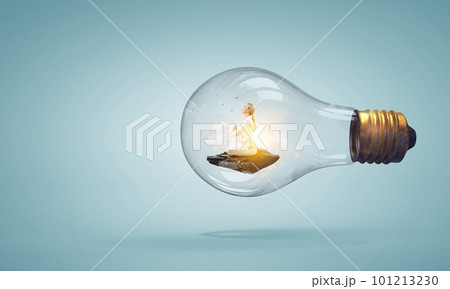 Business woman doing yoga in lotus pose inside light bulb Business woman doing yoga in lotus pose inside light bulb 101213230