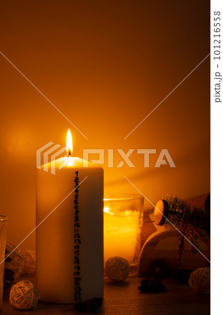 Candle with advent calendar Traditional Burning Christmas Wax Candles with numbers counting down for Christmas. Beautiful Advent At Home. Festive Candlelight And Dark Background Candle with advent calendar Traditional Burning Christmas Wax Candles with numbers counting down for Christmas. Beautiful Advent At Home. Festive Candlelight And Dark Background 101216558