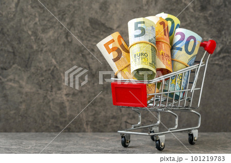 Economic concept. Shopping cart with euro banknotes. Economic concept. Shopping cart with euro banknotes. 101219783