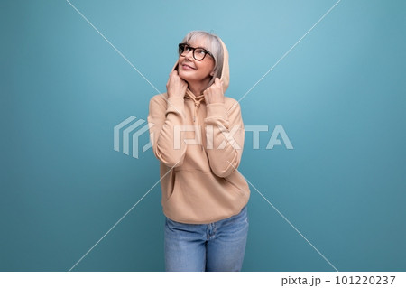 portrait of a kind grandmother with gray hair in a casual youth look on a studio background with portrait of a kind grandmother with gray hair in a casual youth look on a studio background with 101220237
