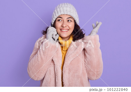 Photo of cheerful pretty lady talking phone and listening fresh news, humor story, laughing and looking aside, wear faux pale pink coat and warm yellow knitted pullover isolated over color background. Photo of cheerful pretty lady talking phone and listening fresh news, humor story, laughing and looking aside, wear faux pale pink coat and warm yellow knitted pullover isolated over color background. 101222840