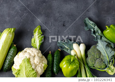 Border of green raw vegetables on black background. Top view of healthy organic food. Copy space Border of green raw vegetables on black background. Top view of healthy organic food. Copy space 101226341