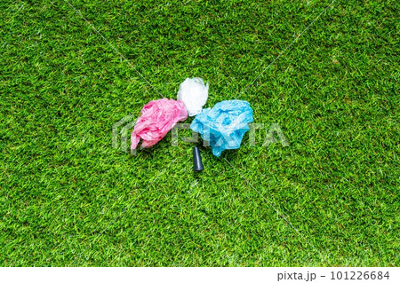 Mouthpiece for shisha om the green grass backround. Plastic waste concept. Plastic trash garbage, save nature. Parts of hookah, tobacco Hookah Shisha Mouthpiece on grass background. 101226684