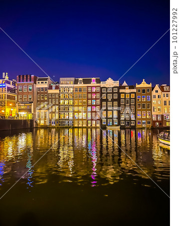 Damrak narrow houses at night in Amsterdam center, Netherlands Damrak narrow houses at night in Amsterdam center, Netherlands 101227992