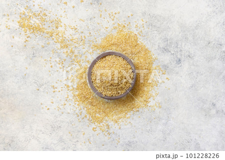 Wooden bowl with Dry uncooked bulgur wheat grain top view. Healthy food Wooden bowl with Dry uncooked bulgur wheat grain top view. Healthy food 101228226
