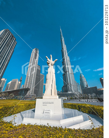 Three Fingers Statue in Burj Park surrounded by skyscrapers in Downtown Dubai, United Arab Emirates 101229713
