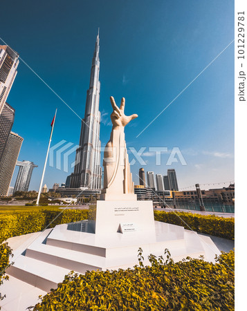 Three Fingers Statue in Burj Park surrounded by skyscrapers in Downtown Dubai, United Arab Emirates 101229781