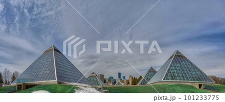Edmonton, Alberta. Mar 30, 2023. Panoramic view of The Muttart Conservatory, Botanical gardens glass pyramids with tropical and arid biomes. Edmonton, Alberta. Mar 30, 2023. Panoramic view of The Muttart Conservatory, Botanical gardens glass pyramids with tropical and arid biomes. 101233775