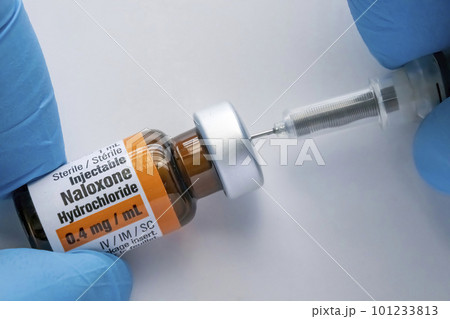 Calgary, Alberta, Canada. Mar 25, 2023.A person using a Naloxone vial with a syringe stock photo Calgary, Alberta, Canada. Mar 25, 2023.A person using a Naloxone vial with a syringe stock photo 101233813