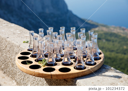 Wooden plate with strong sweet Croatian aperitif fruity drinks like slivovitz, kruskovac and rakija being served outside in de summer in the south of Dalmatia. Typical traditional Croatian liquors 101234372