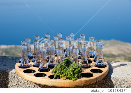 Wooden plate with strong sweet Croatian aperitif fruity drinks like slivovitz, kruskovac and rakija being served outside in de summer in the south of Dalmatia. Typical traditional Croatian liquors 101234374
