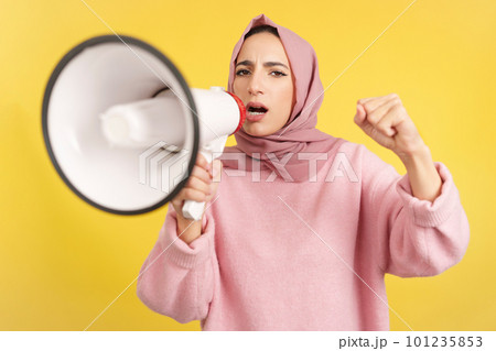 Angry muslim woman screaming using a loudspeaker Angry muslim woman screaming using a loudspeaker 101235853