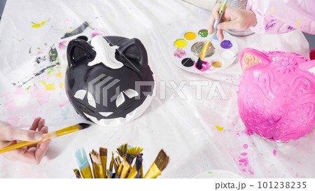Painting craft pumpkin with acrylic paint for Halloween. 101238235