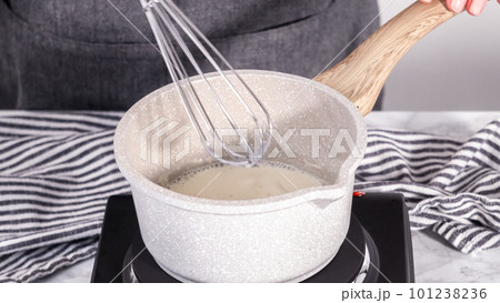Step by step. Preparing tangzhong in a small saucepan to bake homemade bread. 101238236