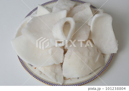 frosted coconut pulp pieces closeup photo on white background 101238804