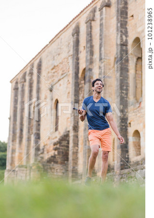 Indian model, mature man dancing Bollywood with smartphone music. Europe travel rhythm on casual. 101238965