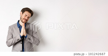 Pleading businessman begging for help, holding hands in pray and asking for favour, need something, say please, standing on white background Pleading businessman begging for help, holding hands in pray and asking for favour, need something, say please, standing on white background 101242687