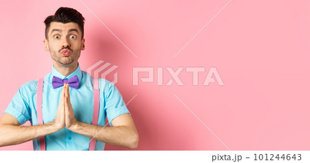Young guy with cute face pucker lips and asking please, begging for favour, need something and lookin gpleading at camera, standing over pink background Young guy with cute face pucker lips and asking please, begging for favour, need something and lookin gpleading at camera, standing over pink background 101244643