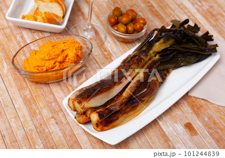 A traditional catalan dish of charred calcot onion and romesco sauce A traditional catalan dish of charred calcot onion and romesco sauce 101244839