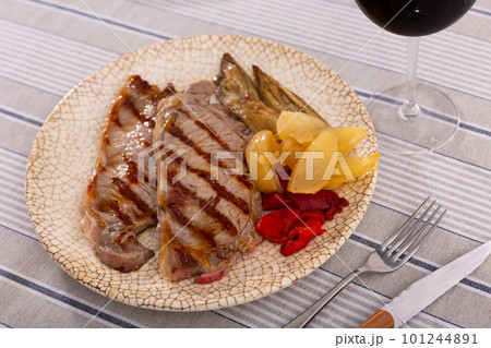 Fried beef with vegetables served on platter 101244891