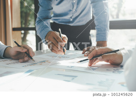 Businessmen working together at desk. 101245620