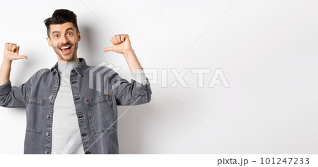 Handsome and confident man smiling, pointing at himself, self-promoting and feeling like professional, standing on white background 101247233